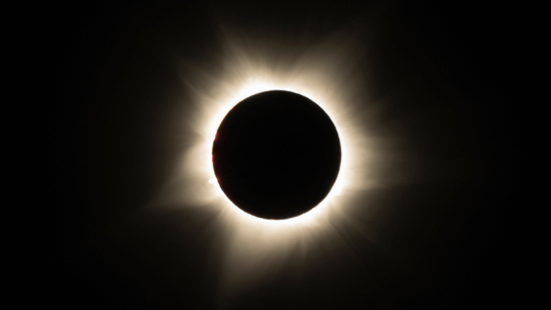 A total solar eclipse with a yellow corona
