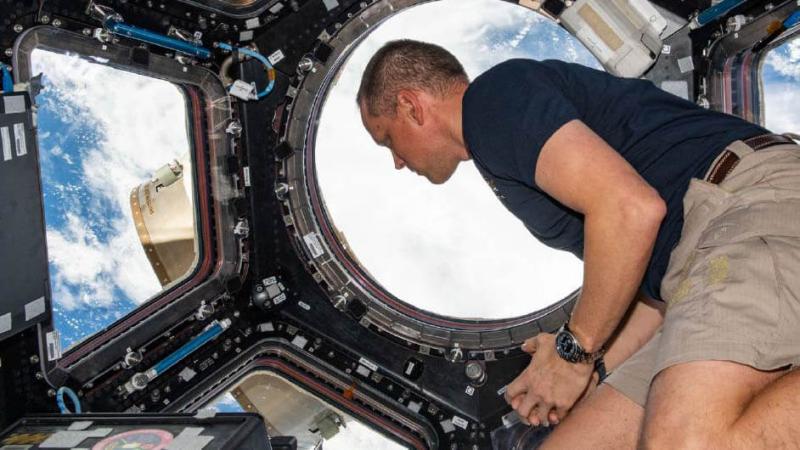 An astronaut in the ISS looking down at Earth.