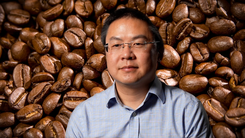 Laurence Yeung in front of coffee beans