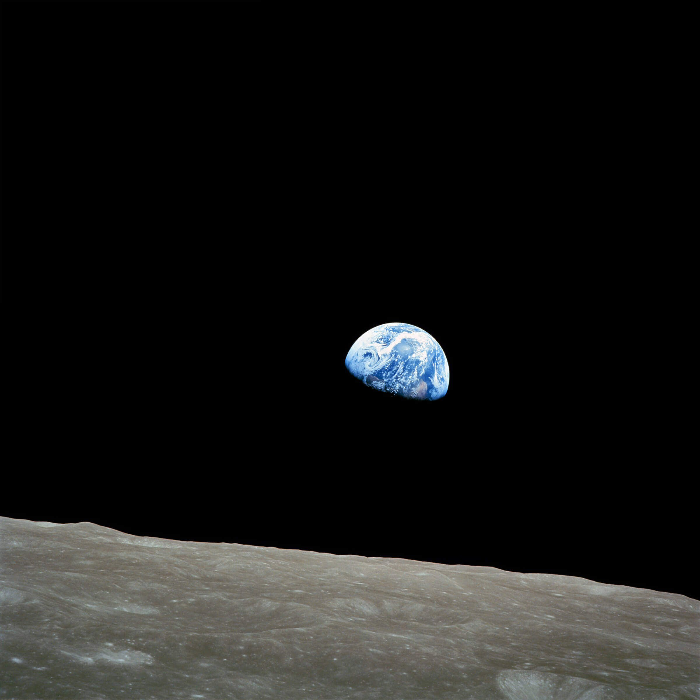 The Apollo 8 "Earthrise" photo - the earth seen from a distance from the surface of the moon.