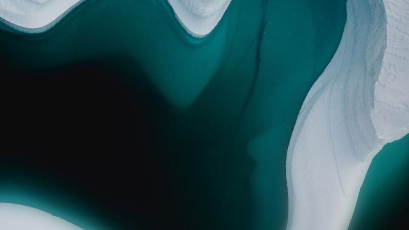 An overhead photo of ice in blue-green water.