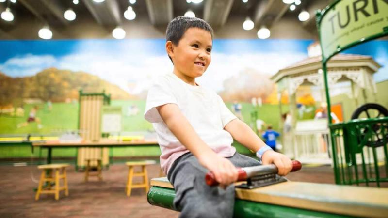 A child on the seesaw in Science in the Park.