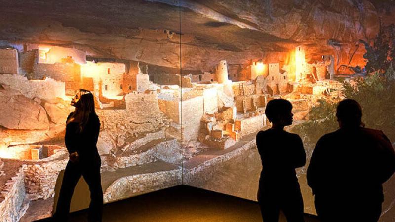 A group of guests seeing Mesa Verde National Park in the Changing Landscape Exhibit.