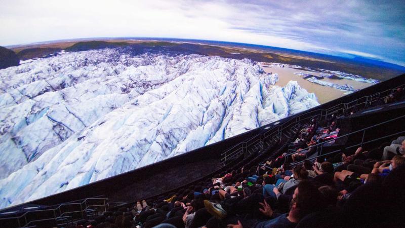 Visitors watching an omni movie about artic ice.