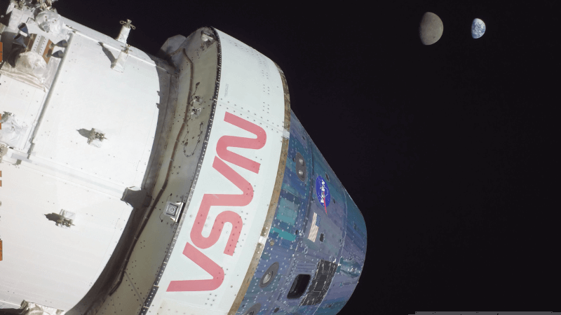 The Orion spacecraft with the Moon and the Earth in the background