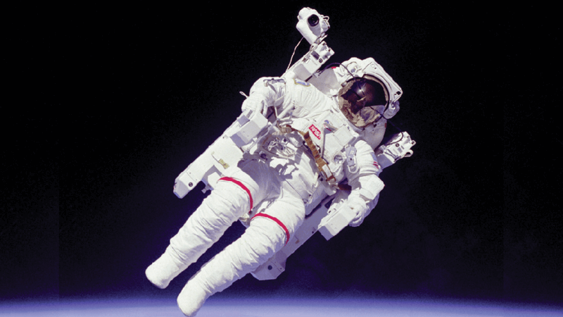 An astronaut on a space walk over Earth