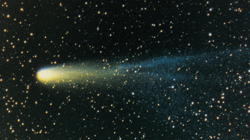 A comet travels across a starry sky
