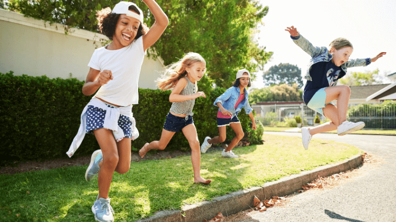 Children run and jump of a curb