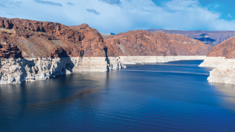 The Colorado River with red and white cliffs on either side