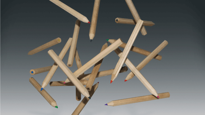 Colored pencils fall agains a grey background