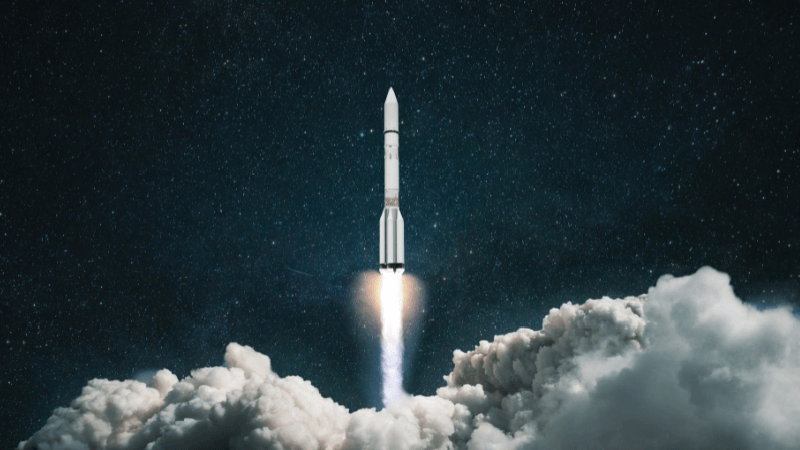 A rocket takes off in a cloud of smoke