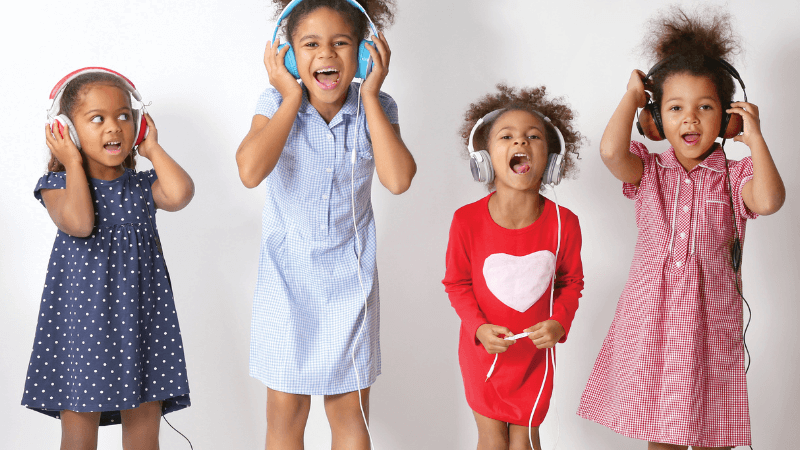 Four children with headphones on yelling