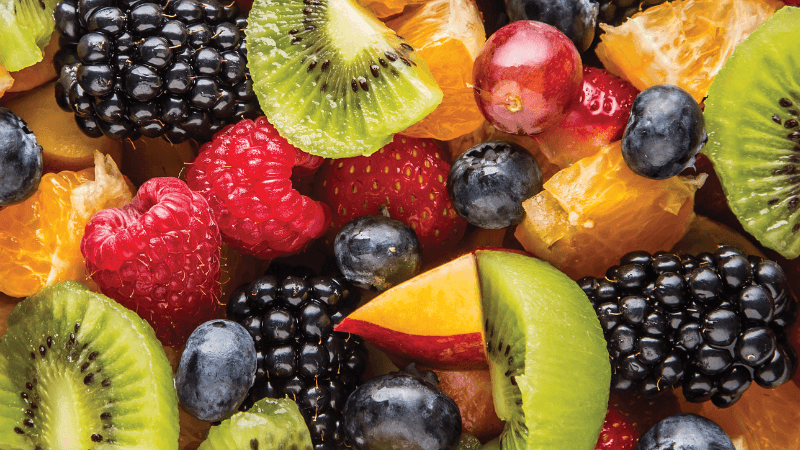 Fruit salad with berries, kiwi, citrus, and grapes