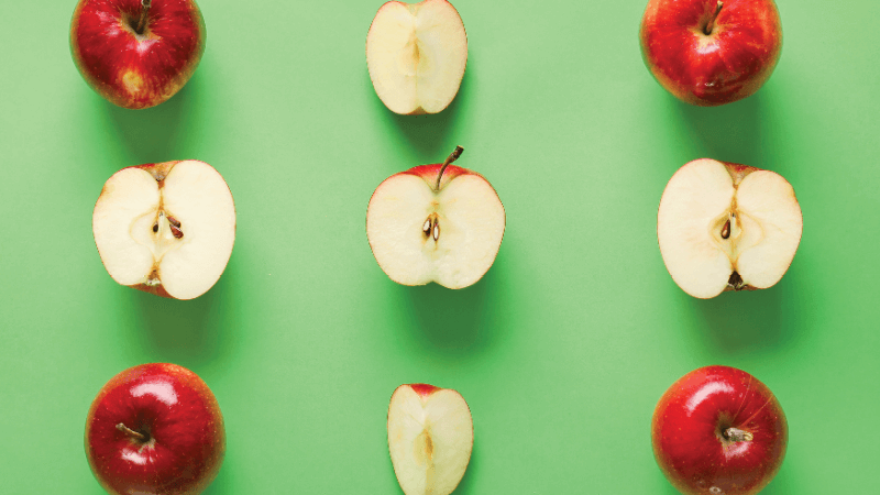 Apples in different amounts on a green background