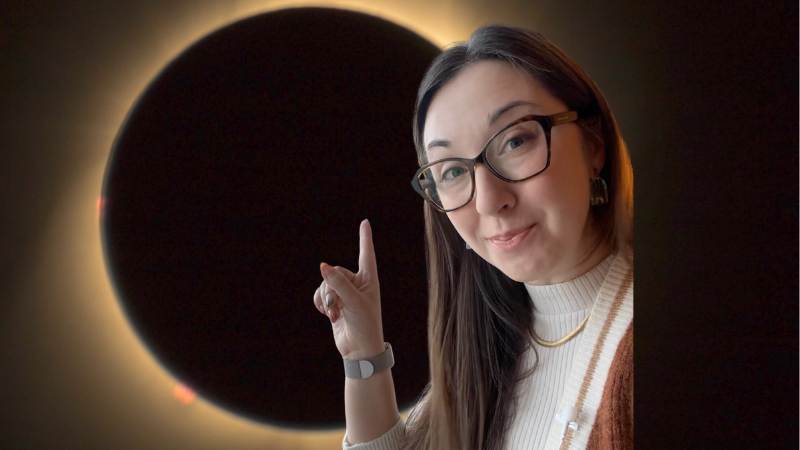 Alex Dainis in front of an eclipse