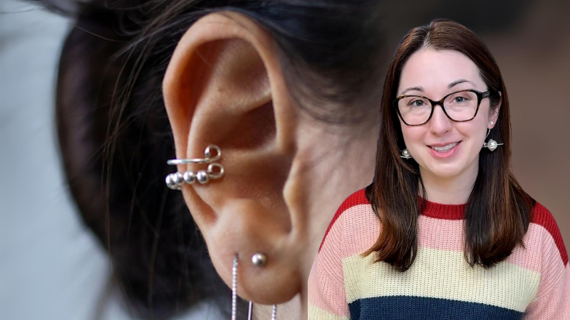 Alex Dainis in front of an ear with piercings