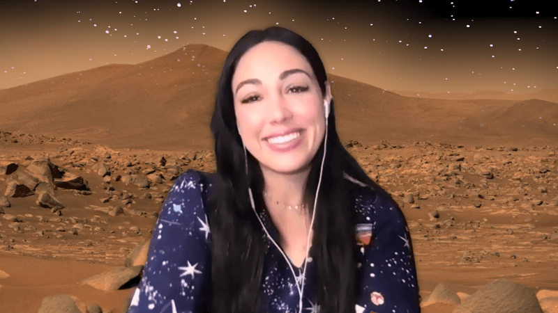 Kellie Gerardi in front of a photo of Mars