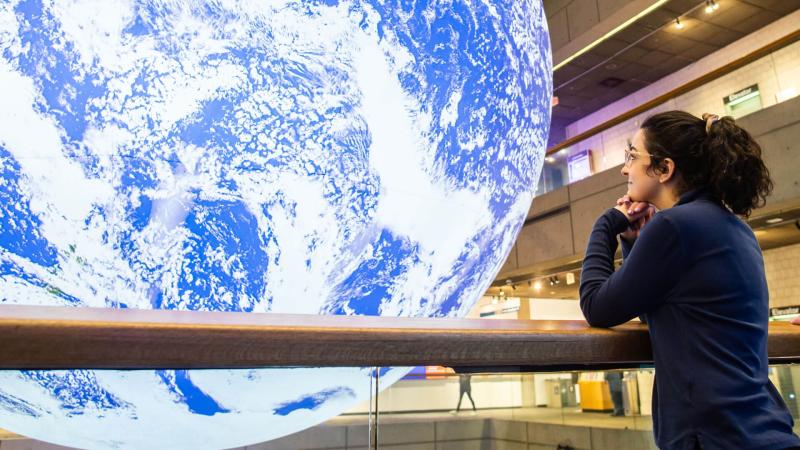 A guest looking out over the balcony of Level 2 at the Gaia installation.