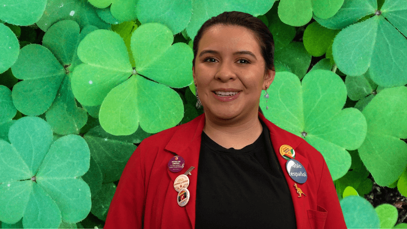 Museum Educator Ana in front of clovers