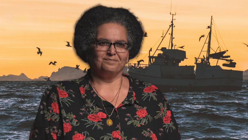 Niaz Dorry in front of an image of a boat on the ocean