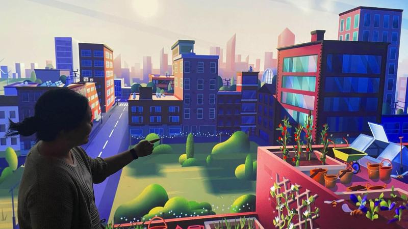 A guest exploring a virtual city in the Innovation Earth Exhibit.