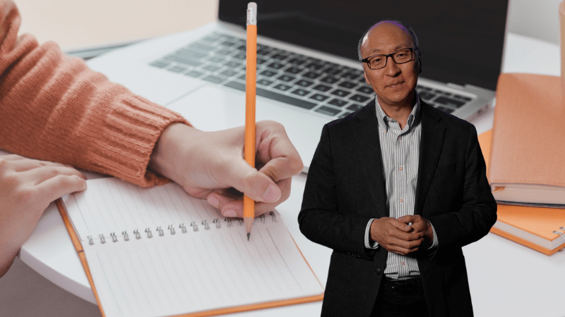 Insoo Hyun in front of an image of a hand writing