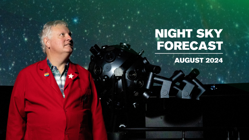 Planetarium Educator Chuck Wilcox standing by the Planetarium projector.