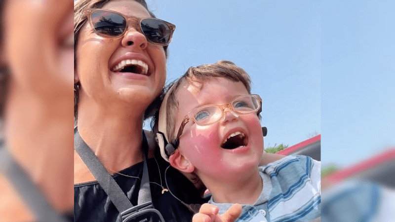 Beth Leipholtz of Beth & Coop with her Deaf son Cooper against a blue sky