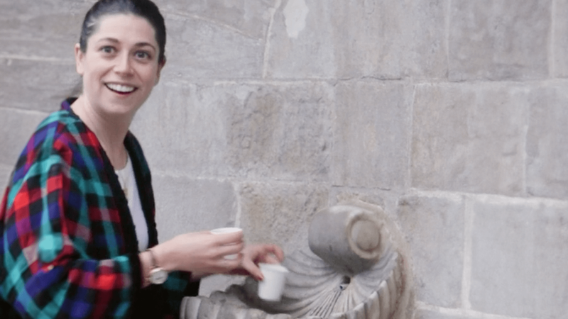 Sophie Shrand takes water from a spring water fountain