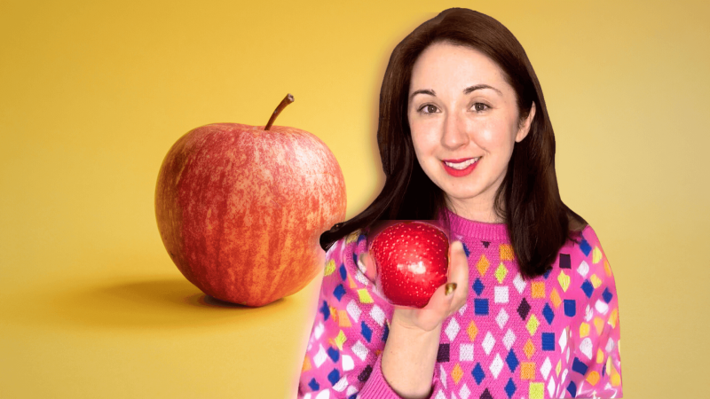 Alex Dainis holding an apple in front of an image of an apple