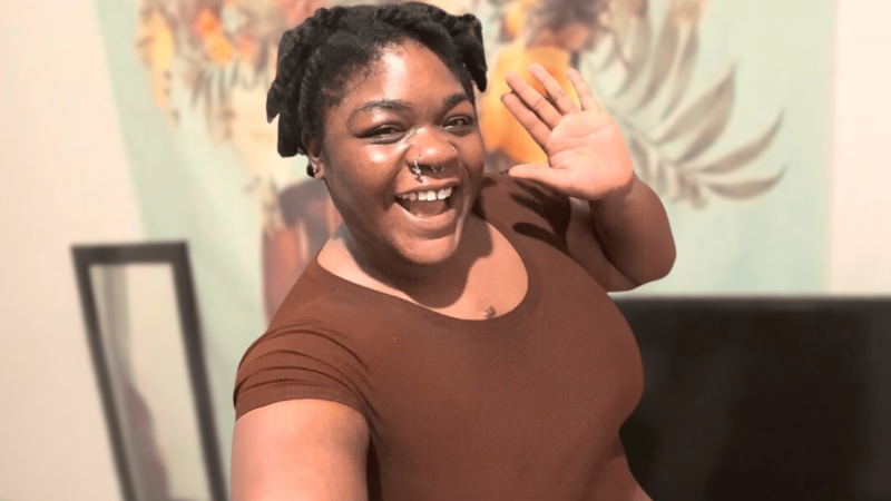 Lindsay Ejoh smiling and waving at the camera