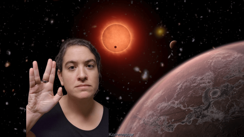 Talia giving the live long and prosper gesture in front of an image of stars and planets