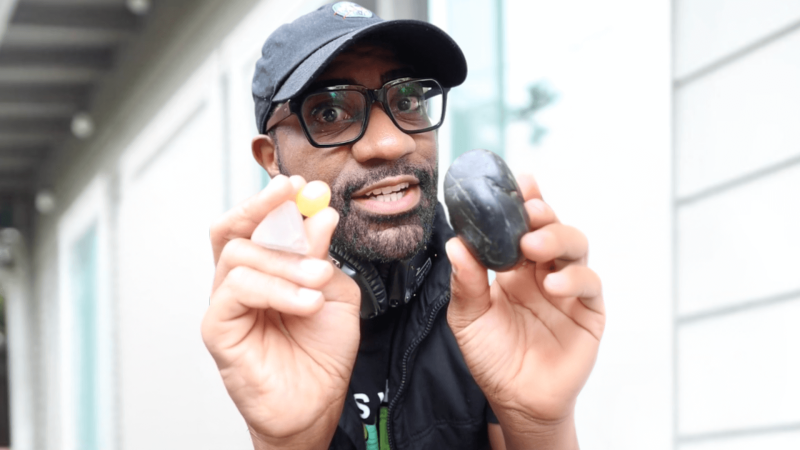 Maynard Okereke holding up rocks
