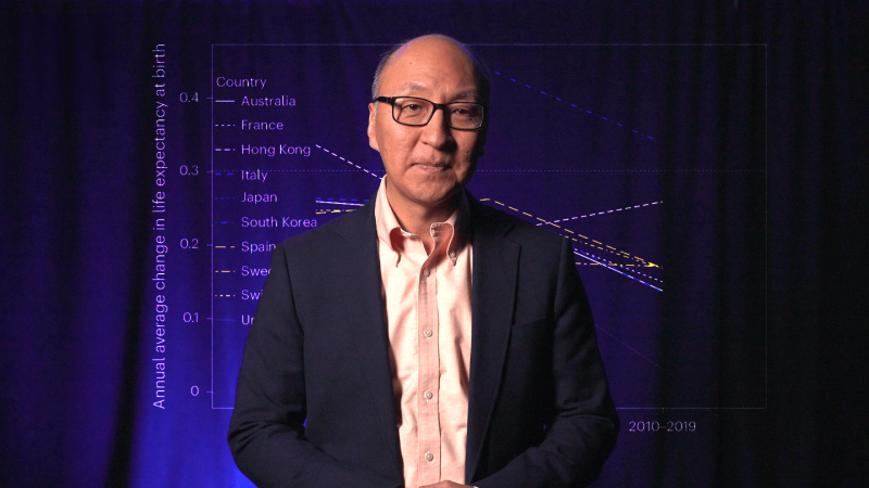 Insoo Hyun with an image of a graph charting human lifespan