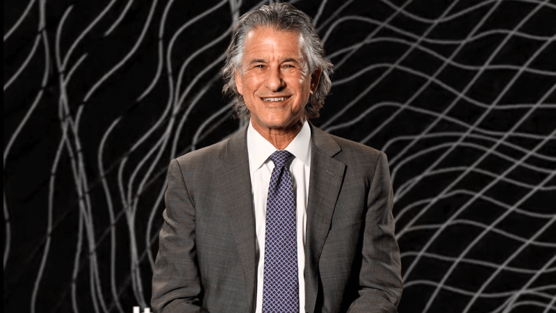 Daniel Levitin in front of an image of sound waves