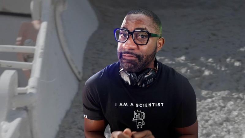 Maynard Okereke in front of an image of cement