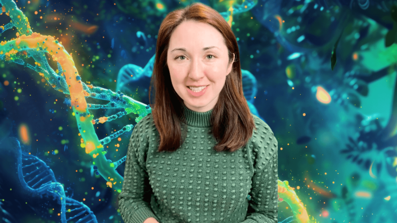 Alex Dainis in front of an image of DNA