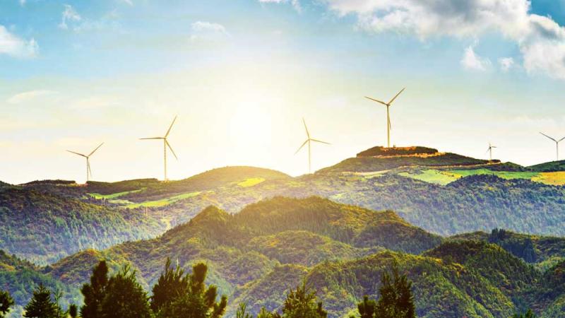 A beautiful landscape with windmills in the distance.