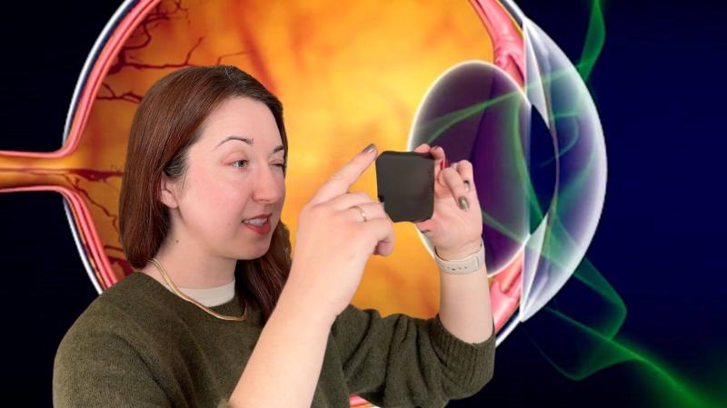 Alex Dainis in front of a diagram of an eyeball