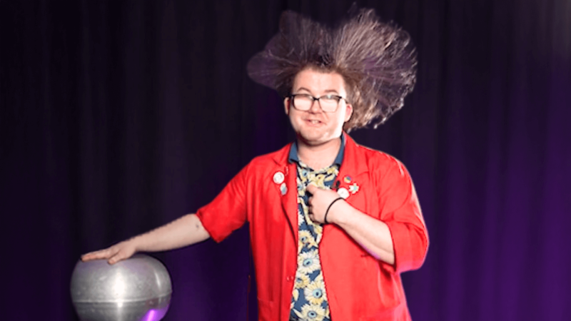 Museum Educator Locke with a Van de Graaf generator, with his hair standing on end