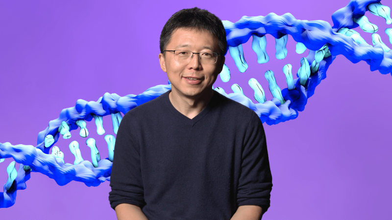 Feng Zhang in front of an image of DNA