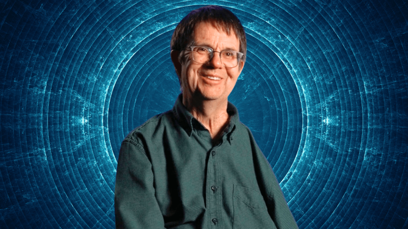 Eric Cornell in front of a blowing blue circle