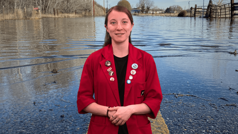 Educator Sloane in front of a high tide