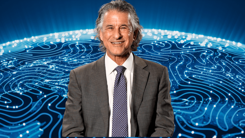 Daniel Levitian in front of an artist's rendition of neural connections