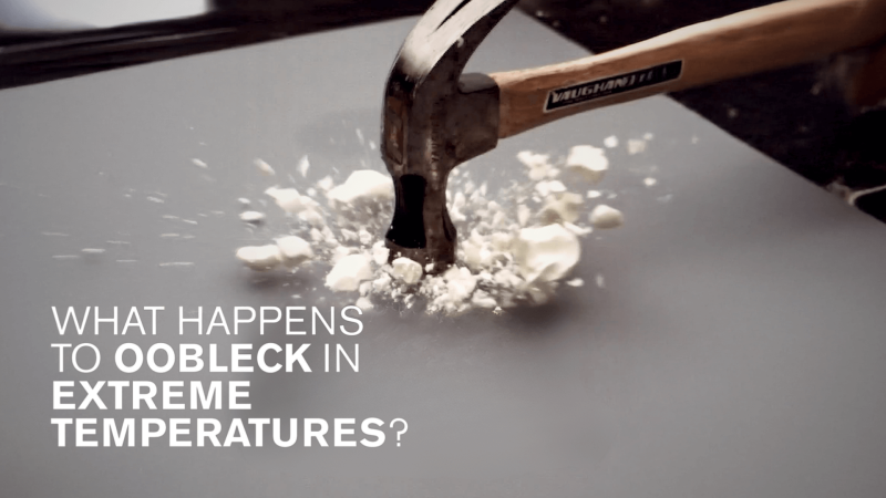 A hammer hitting and shattering frozen oobleck with the white text saying "What happens to oobleck in extreme temperatures?"