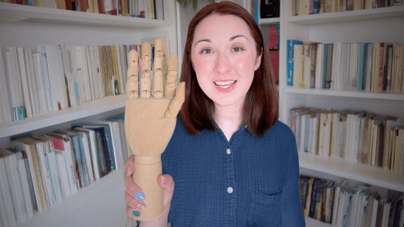 Alex Dainis holds up a fake hand