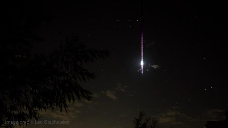 A fireball shoots across a dark sky.