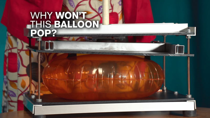 A balloon pressed between two panels with white text reading "Why Won't This Balloon Pop?"
