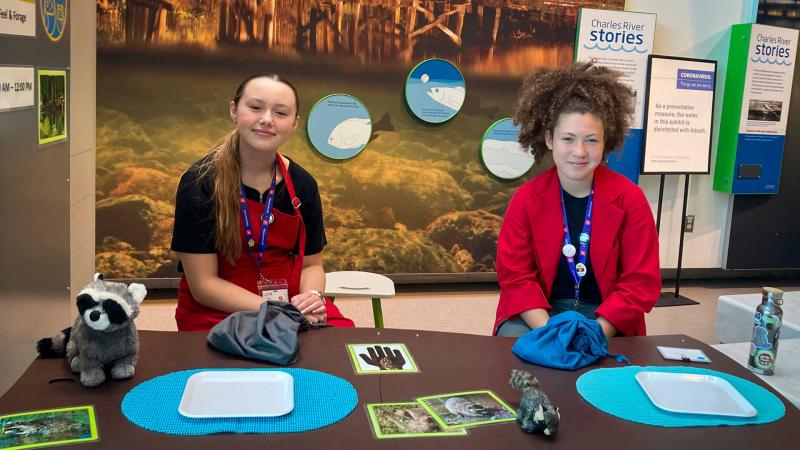 Two student interns facilitating a table-activity in the Museum.