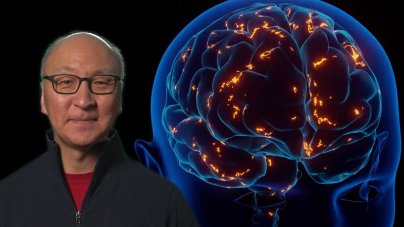 Insoo Hyun in front of a glowing brain